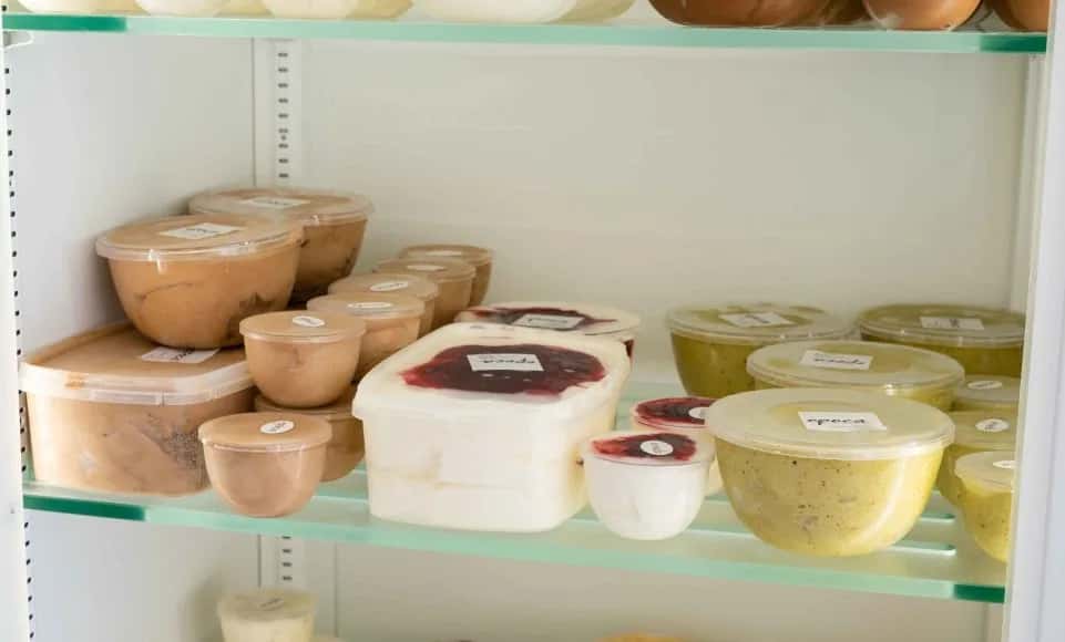 Tubs of house-made ice cream and frozen desserts in the freezer display