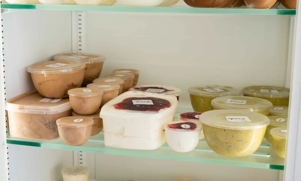 Tubs of house-made ice cream and frozen desserts in the freezer display